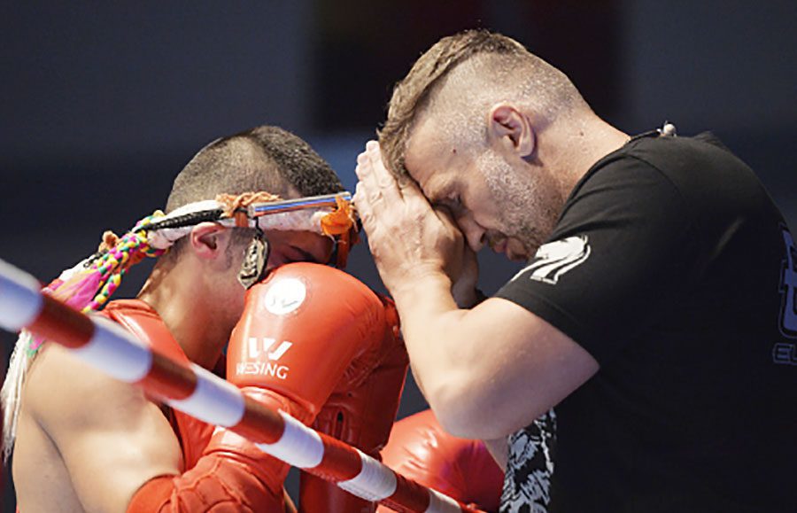 Muaythai fighter and coach engage in a pre-match ceremony | International Federation of Muaythai Associations (IFMA)
